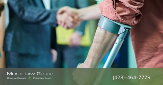Injured man shaking the hand of an attorney